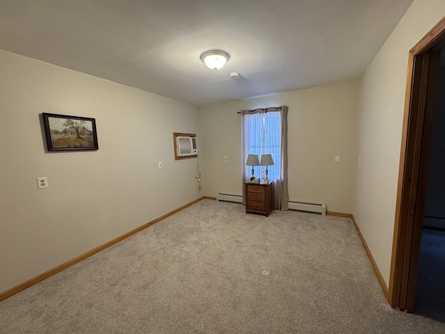 spare room featuring a baseboard radiator, light carpet, and a wall mounted AC