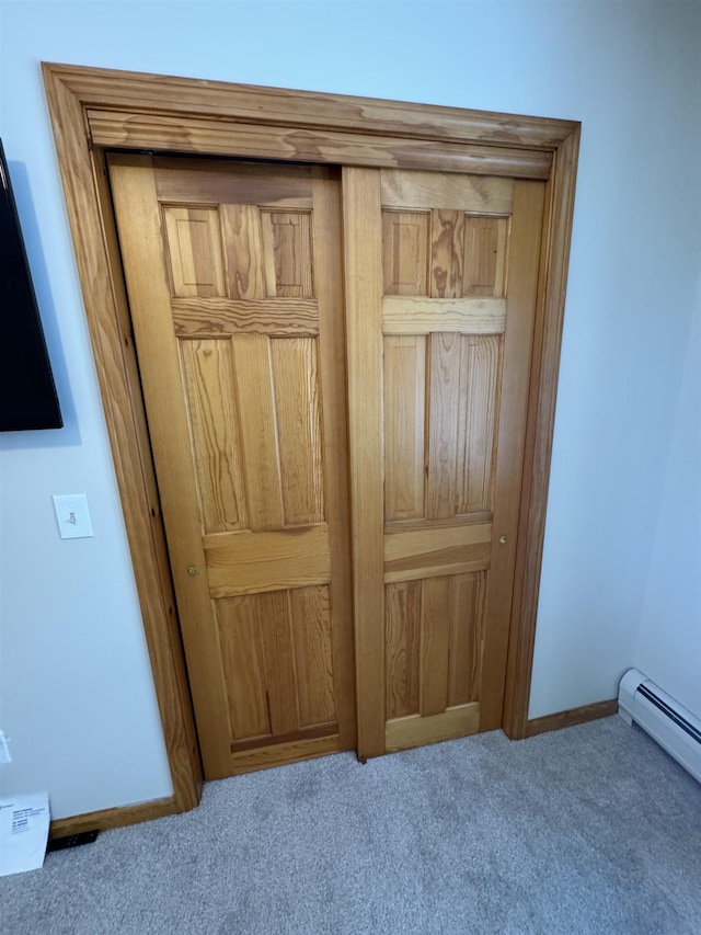 room details with a baseboard radiator and carpet