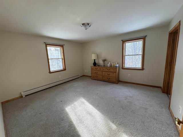 unfurnished bedroom featuring light carpet and a baseboard radiator