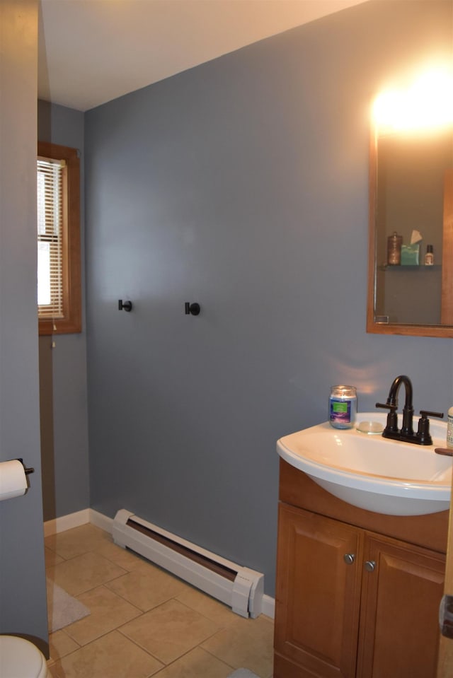 bathroom with vanity, a baseboard heating unit, tile patterned floors, and toilet