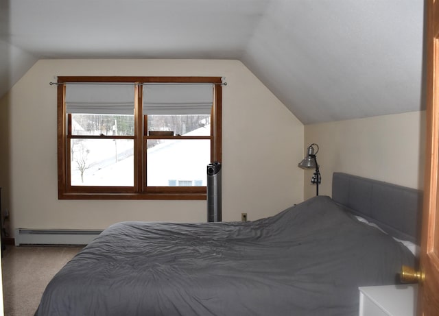 carpeted bedroom featuring lofted ceiling and a baseboard heating unit