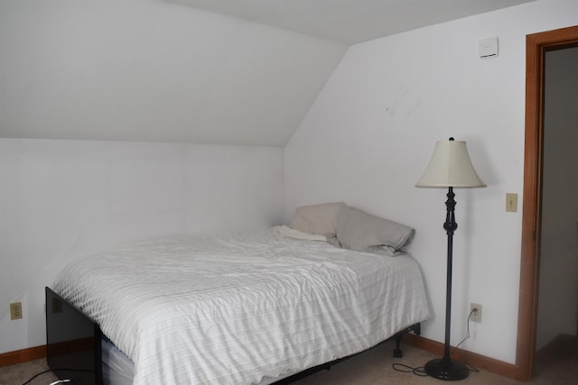 carpeted bedroom with vaulted ceiling