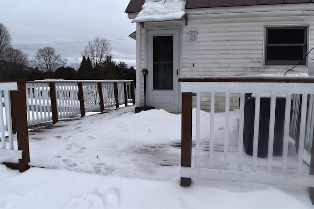 view of snow covered property entrance