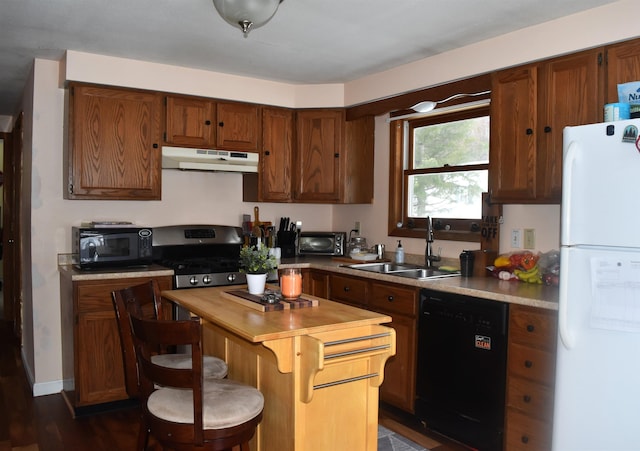 kitchen with sink, dark hardwood / wood-style floors, and black appliances