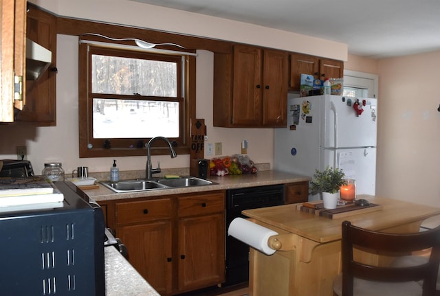 kitchen featuring sink, black dishwasher, and white fridge