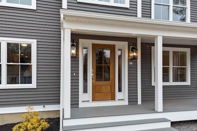 view of exterior entry with covered porch