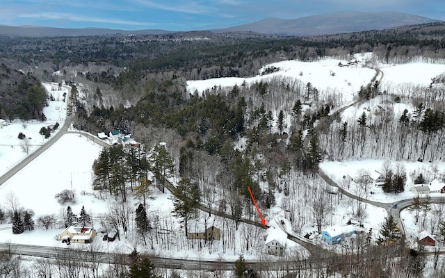 snowy aerial view featuring a mountain view