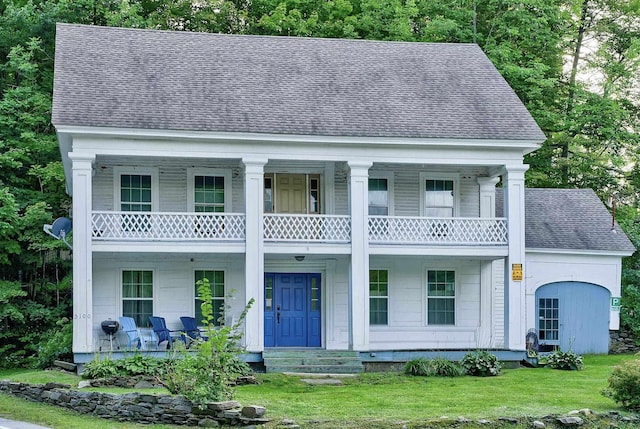 neoclassical / greek revival house featuring a balcony and a porch