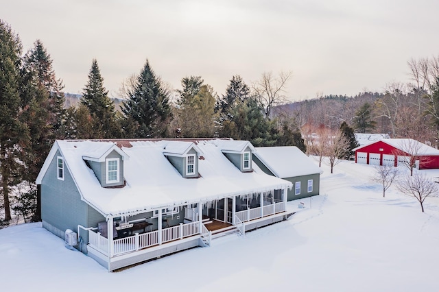 view of front of property with a porch, a sunroom, and a garage