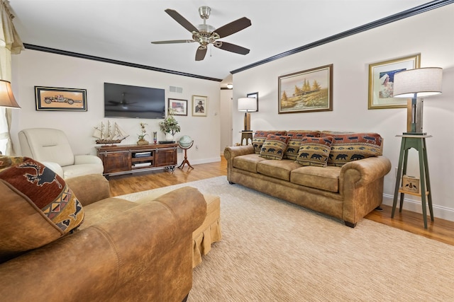 living room featuring crown molding, ceiling fan, and light wood-type flooring