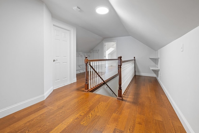 bonus room with hardwood / wood-style flooring and lofted ceiling