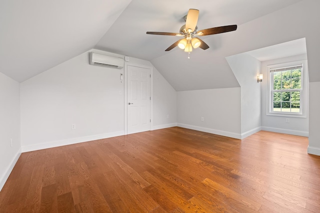 bonus room featuring an AC wall unit, hardwood / wood-style floors, lofted ceiling, and ceiling fan