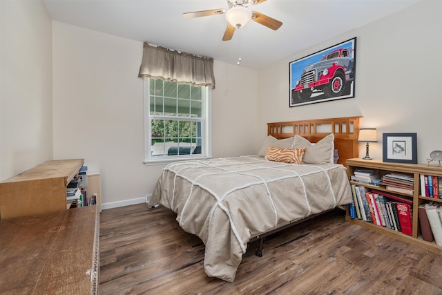 bedroom featuring dark wood-type flooring and ceiling fan