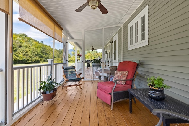 wooden deck featuring ceiling fan and a porch