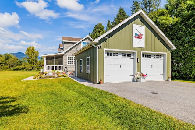 view of front of home featuring a garage, covered porch, and a front lawn