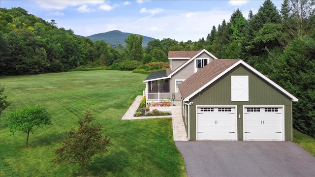 view of front of house with a mountain view, a garage, and a front yard