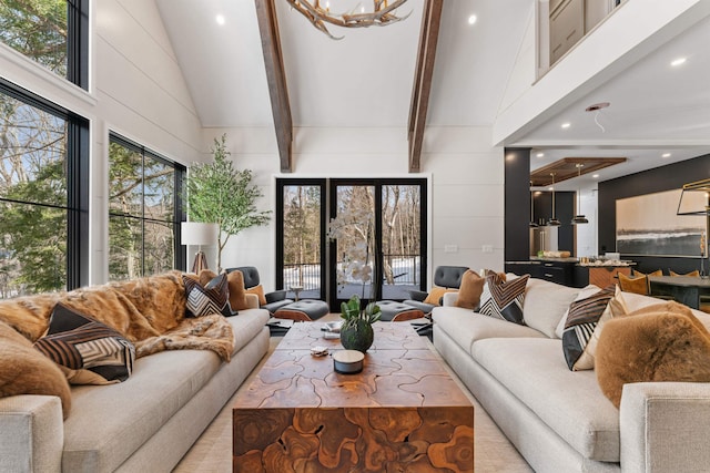 interior space featuring an inviting chandelier, high vaulted ceiling, and beamed ceiling