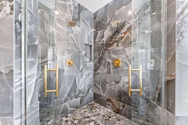 bathroom featuring a shower with shower door