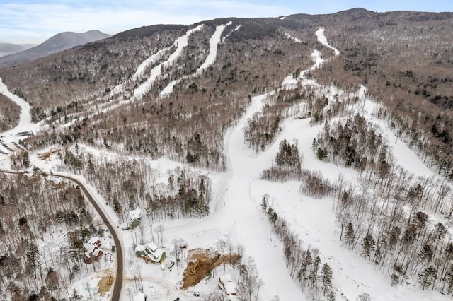 snowy aerial view with a mountain view