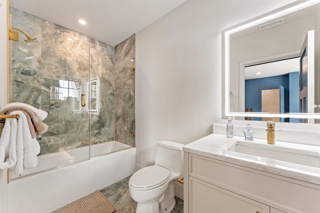 full bathroom with vanity, combined bath / shower with glass door, and toilet