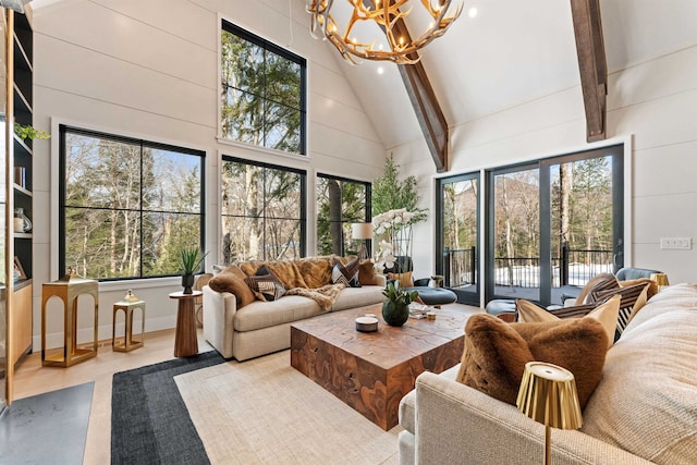 sunroom / solarium with vaulted ceiling with beams and a chandelier