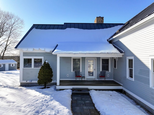 view of front of home with a shed and covered porch