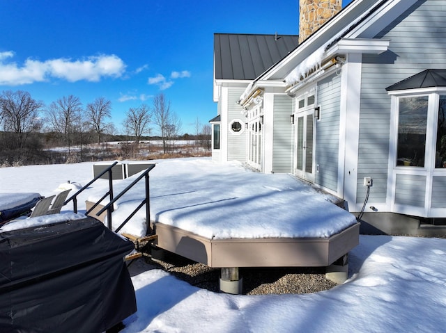 snow covered deck with grilling area