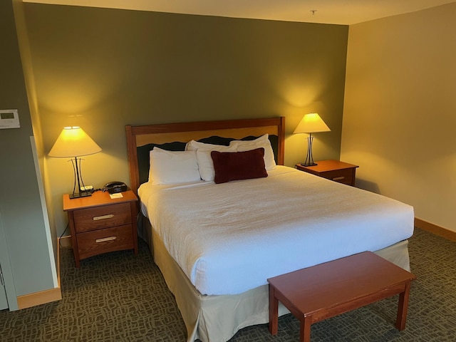 bedroom with dark colored carpet