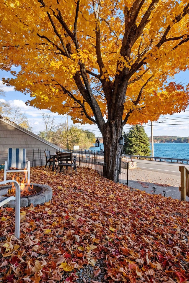 view of yard featuring an outdoor fire pit and a water view