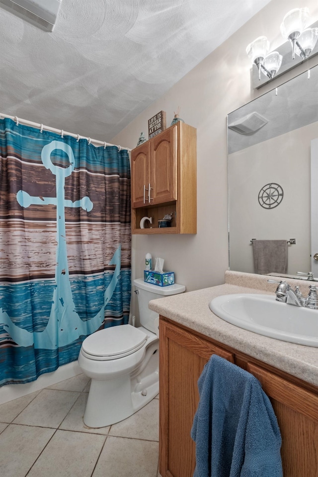 bathroom featuring curtained shower, vanity, toilet, tile patterned floors, and a textured ceiling