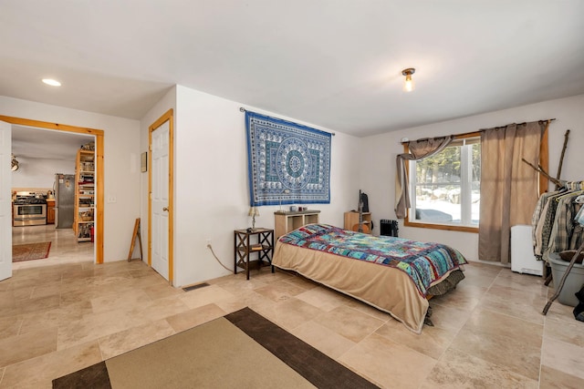 bedroom featuring stainless steel refrigerator