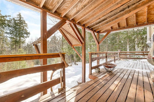 snow covered deck with an outdoor fire pit