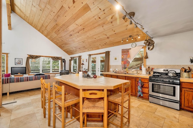 dining space featuring high vaulted ceiling, sink, wood ceiling, track lighting, and french doors