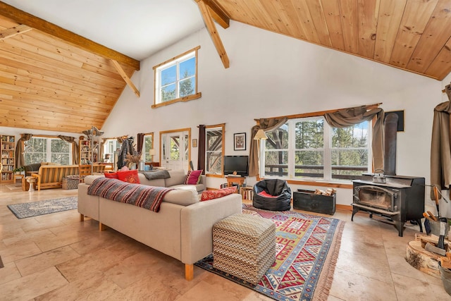 living room with beamed ceiling, a wood stove, wooden ceiling, and high vaulted ceiling