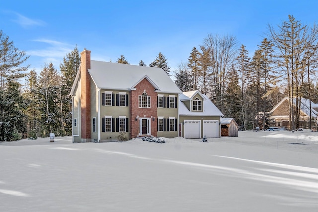 view of front of property with a garage, brick siding, and a chimney