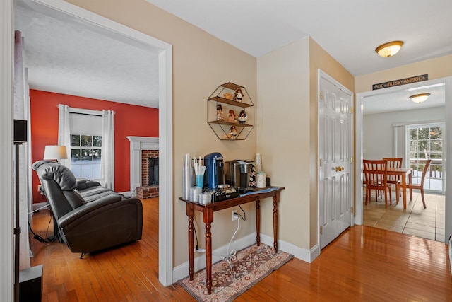 hallway featuring wood finished floors and baseboards