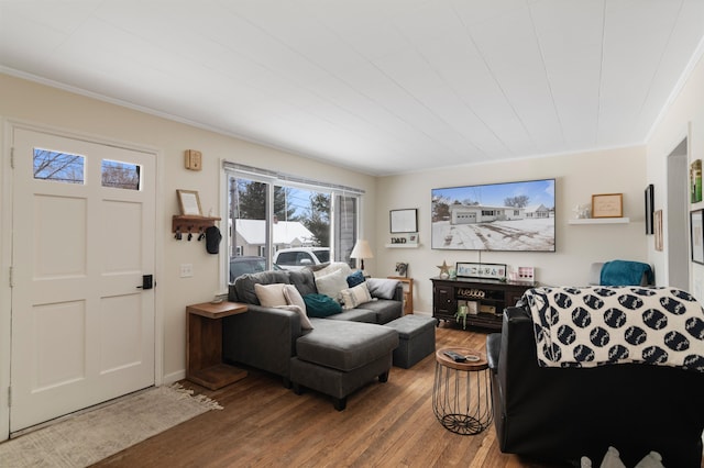 living room featuring hardwood / wood-style flooring and ornamental molding