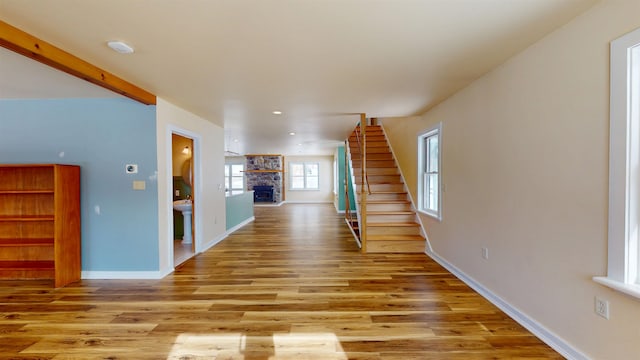 interior space with a stone fireplace and light hardwood / wood-style floors