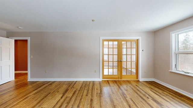 unfurnished room featuring light hardwood / wood-style floors and french doors