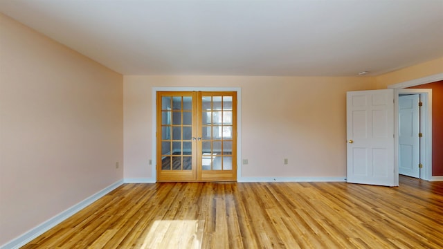 empty room featuring light hardwood / wood-style floors and french doors