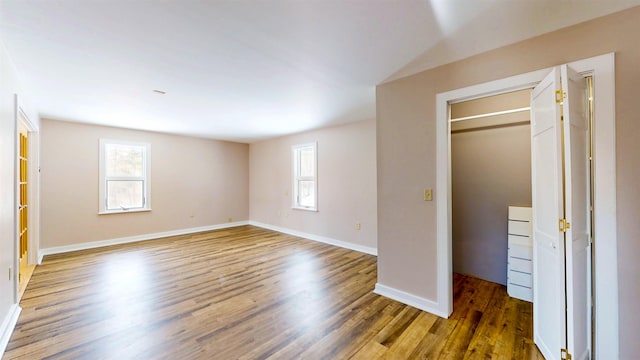 unfurnished bedroom with dark hardwood / wood-style floors