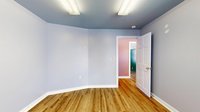 unfurnished room with light wood-type flooring