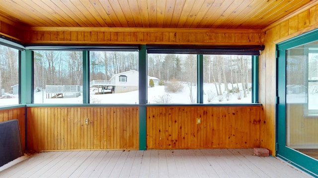 unfurnished sunroom with wood ceiling