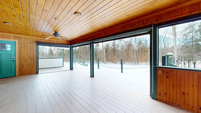 unfurnished sunroom with ceiling fan and wood ceiling