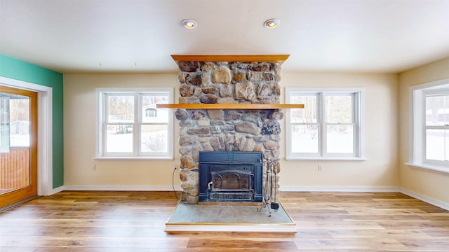 unfurnished living room featuring a fireplace and light hardwood / wood-style flooring