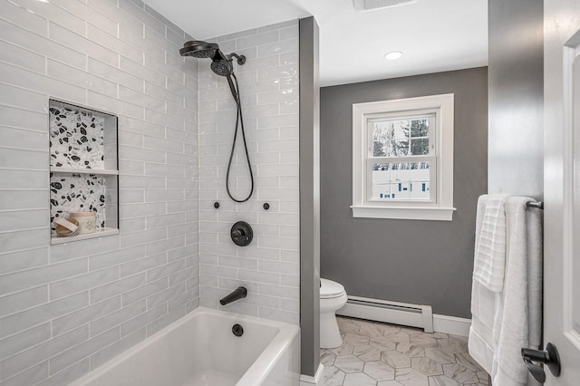 bathroom with tile patterned flooring, tiled shower / bath combo, baseboard heating, and toilet