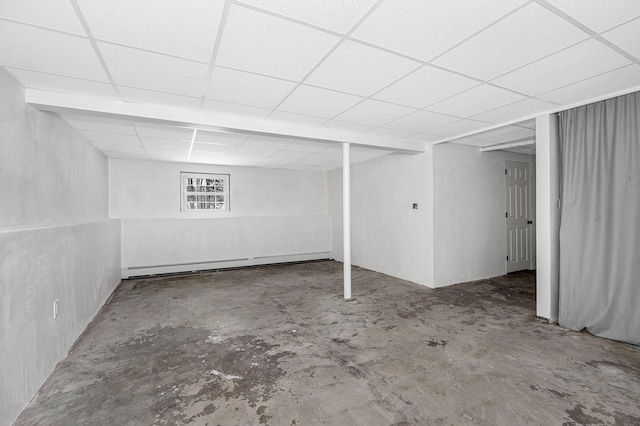 basement with a drop ceiling and baseboard heating