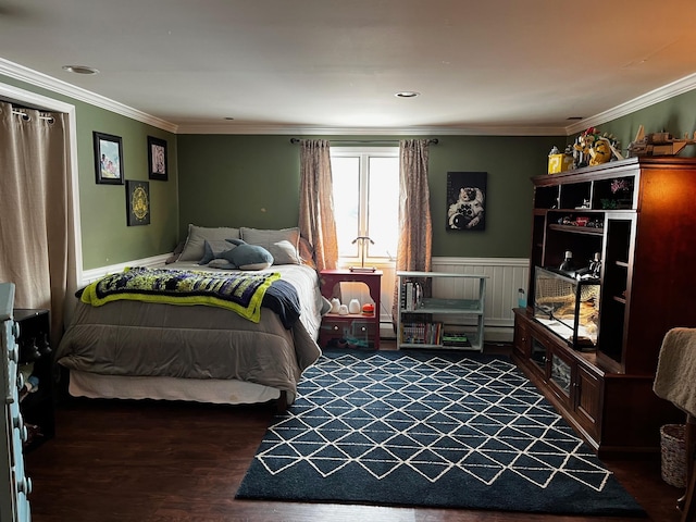 bedroom with dark wood-style flooring, wainscoting, and crown molding