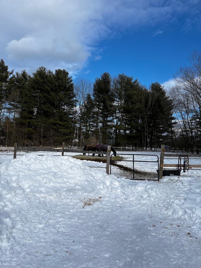 yard covered in snow with fence