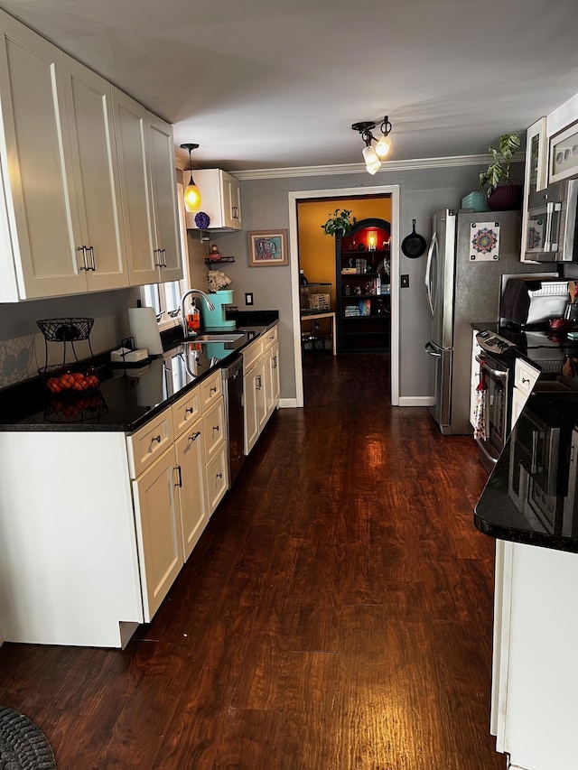 kitchen featuring stainless steel appliances, white cabinetry, a sink, and dark wood-type flooring